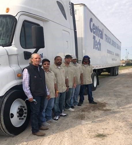 group photo in front of a white truck 