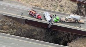 Semi truck driver helps save couple in pickup hanging by chain from bridge