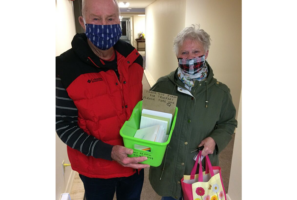 Thankful senior citizen hands out cards to show truckers appreciation