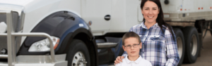 Mom with son in front of semi truck