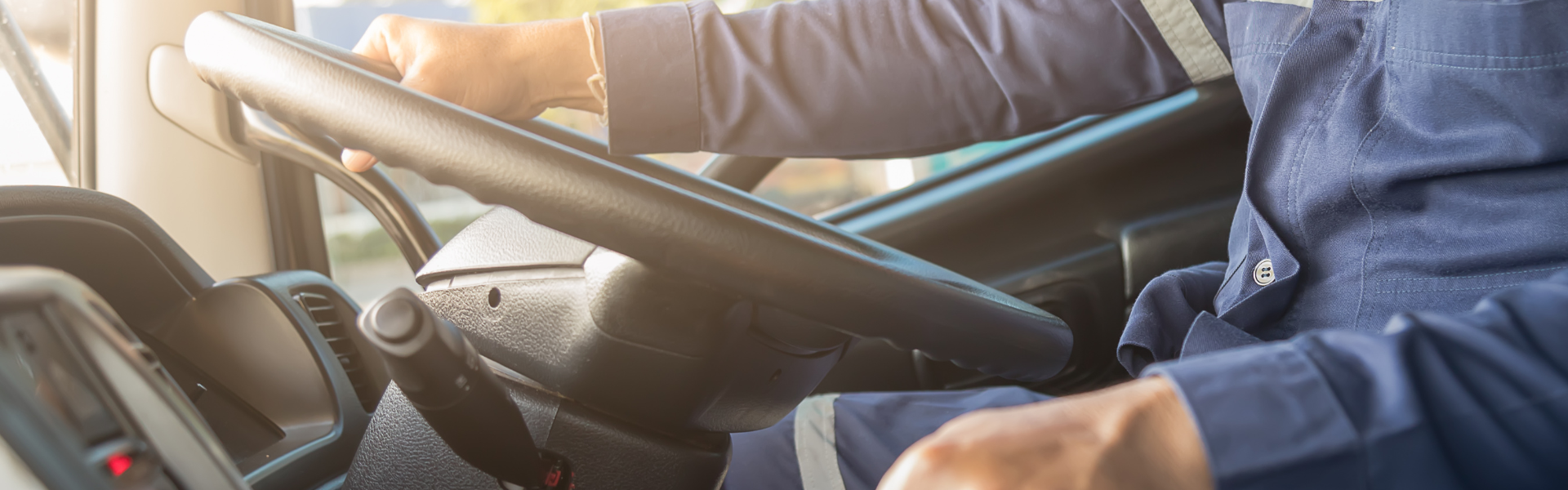 Truck driver behind the wheel of semi truck