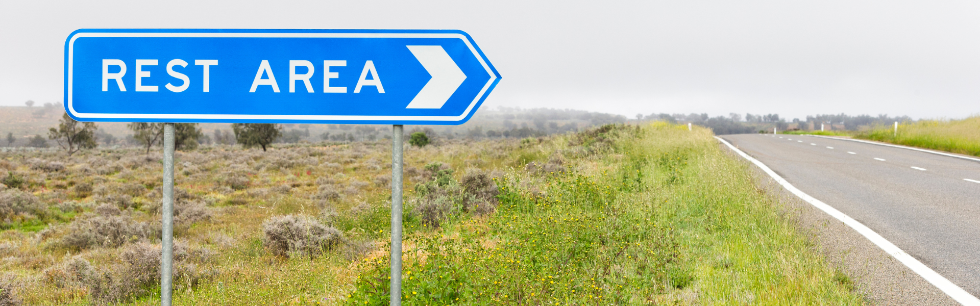 Roadside sign pointing toward a rest area