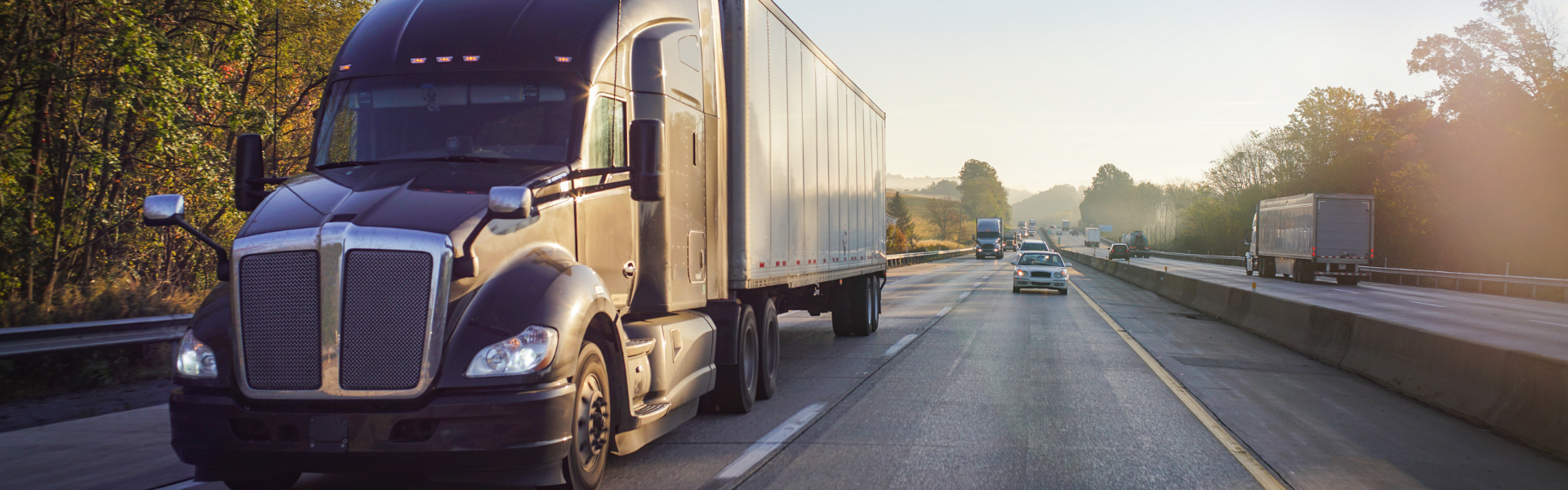 semi truck in traffic on 4-lane road