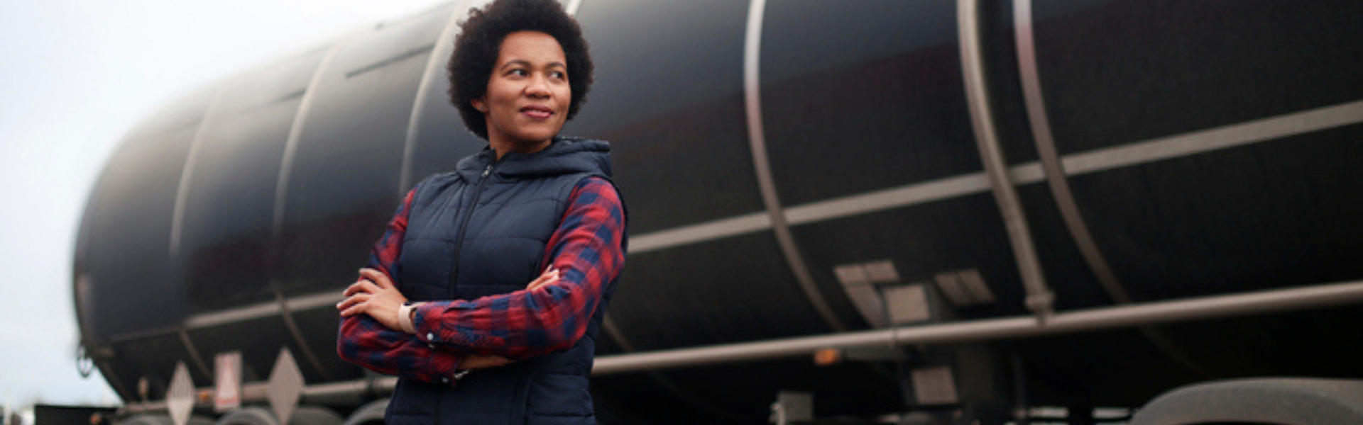 black woman standing near tanker semi truck