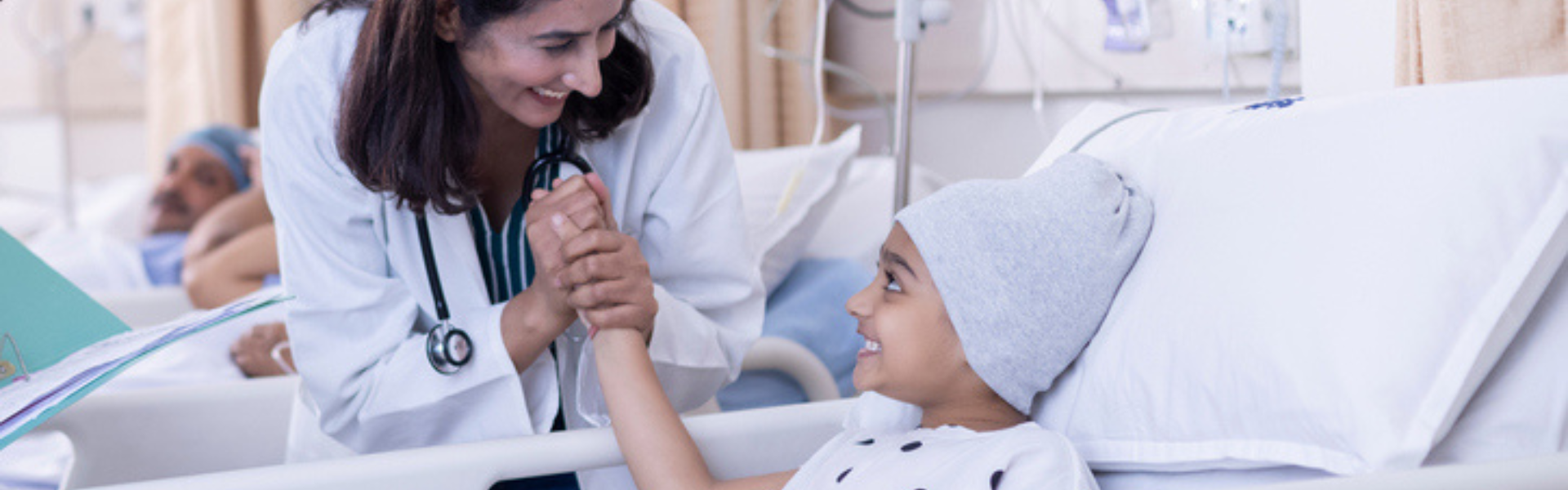 cancer patient child in hospital bed with nurse