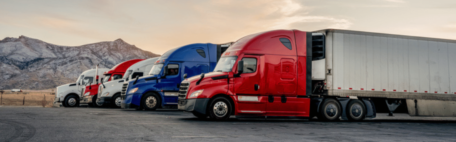 semi trucks with mountains in background