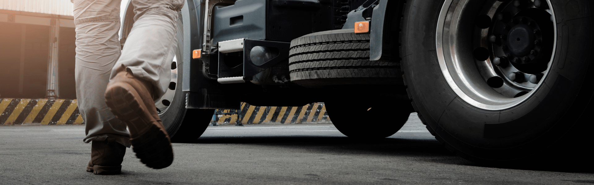 man in work boots walking towards semi truck