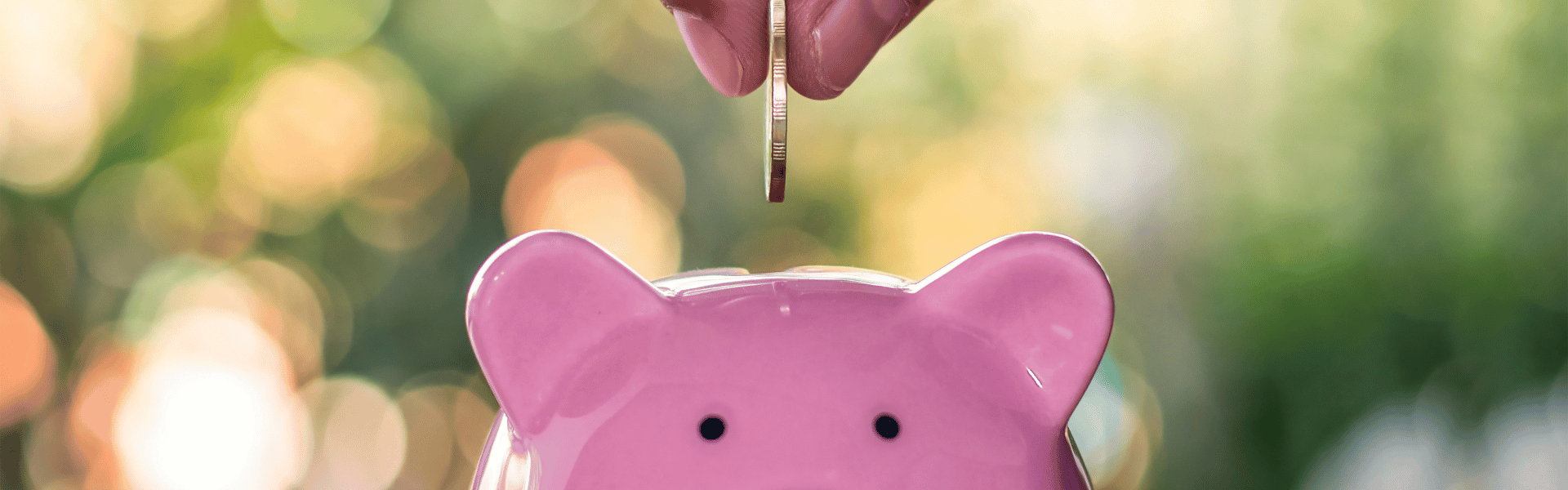 dropping a coin into a piggy bank