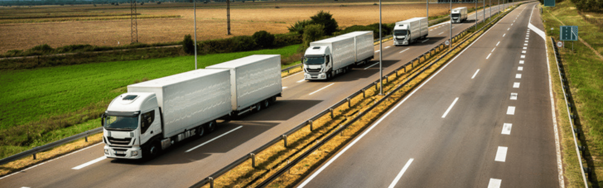 line of electric semi trucks on highway