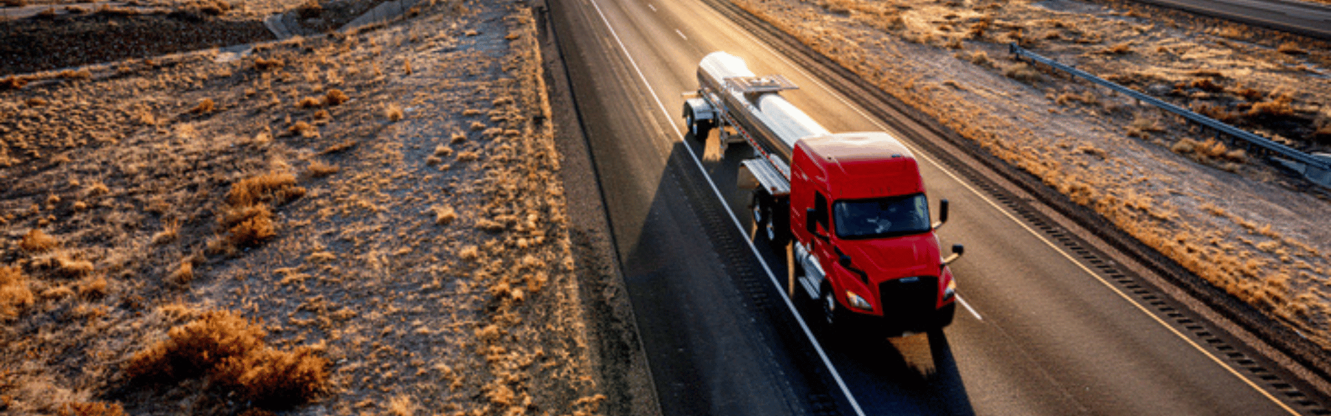 Tanker truck on highway with mountains in background
