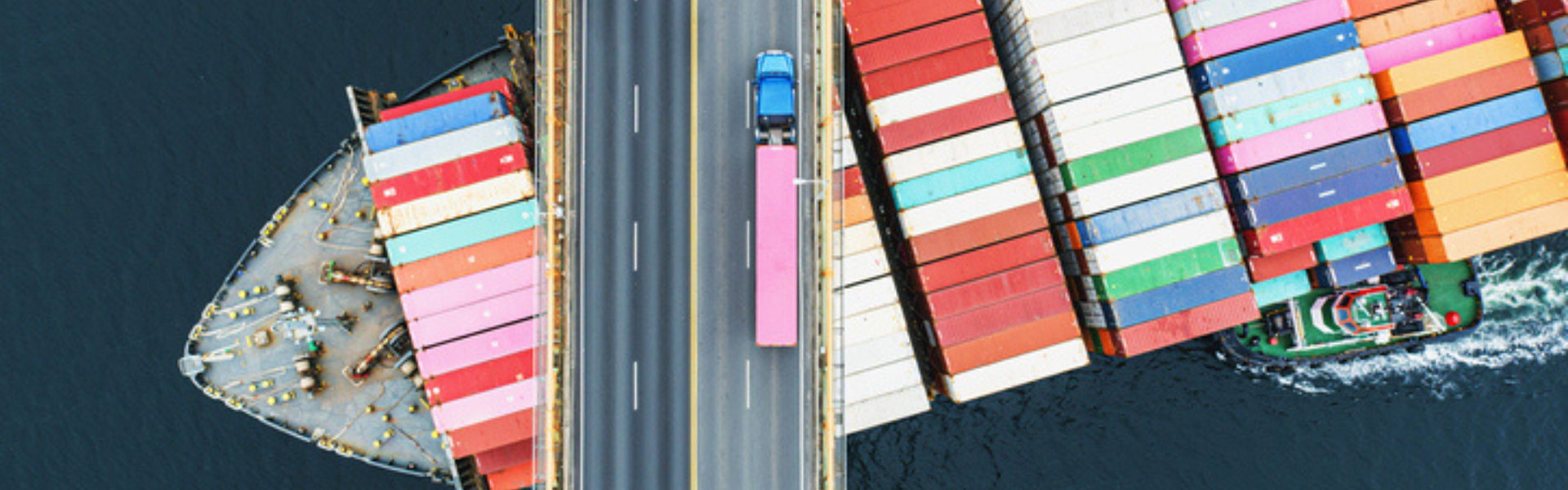 Semi truck on bridge over freight barge