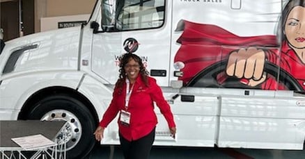 Woman standing in front of Volvo semi 