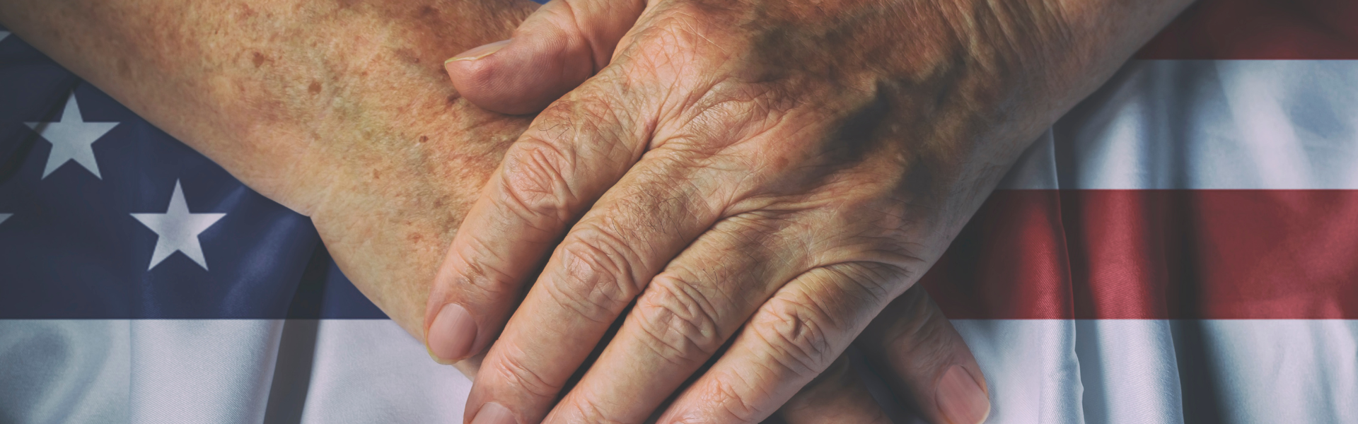 hands folded over flag