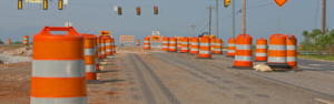 road with orange road construction barrels