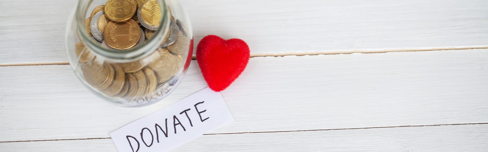 jar of coins with a donate note