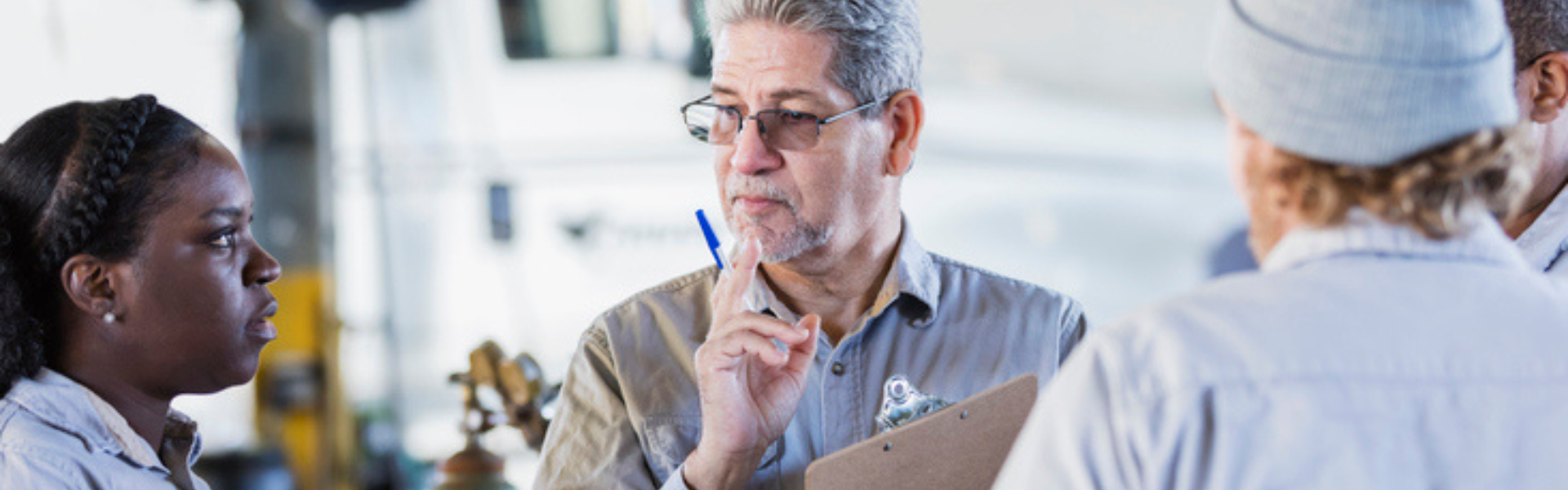 Instructor with students with semi truck in background