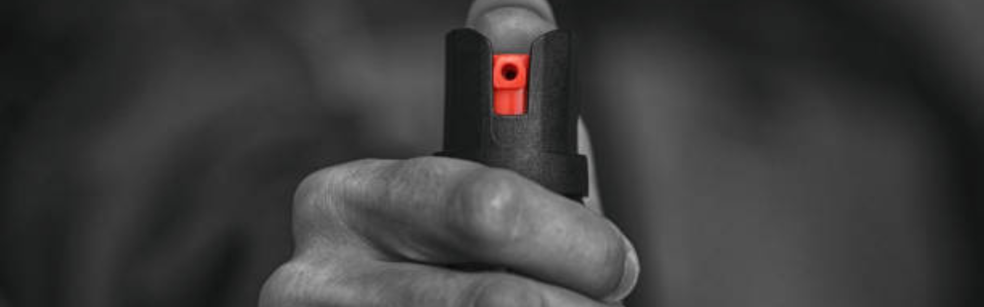 Man holding can of mace