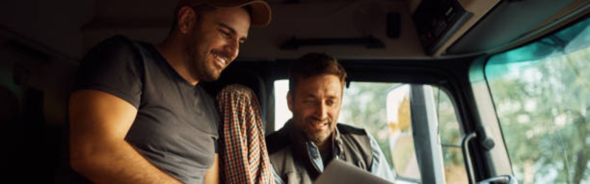 two men in the cab of a semi truck