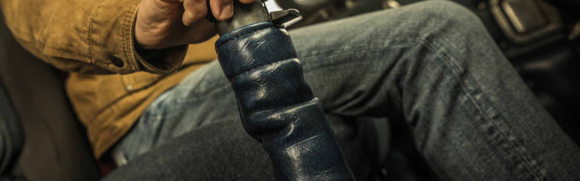 man sitting in drivers seat of semi truck