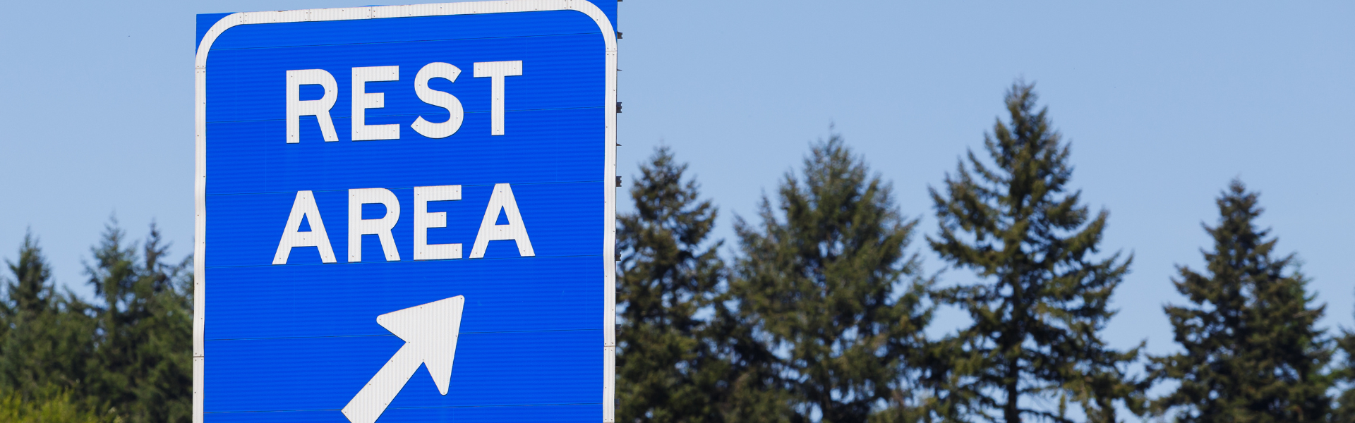 road sign pointing to rest area exit