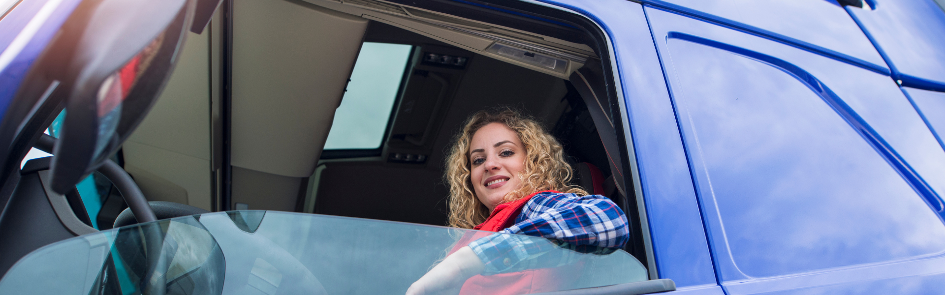 woman sitting in drivers seat of semi truck