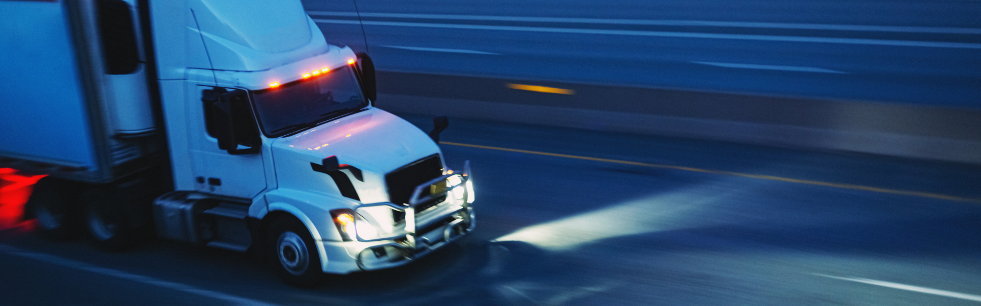 semi truck on road at night