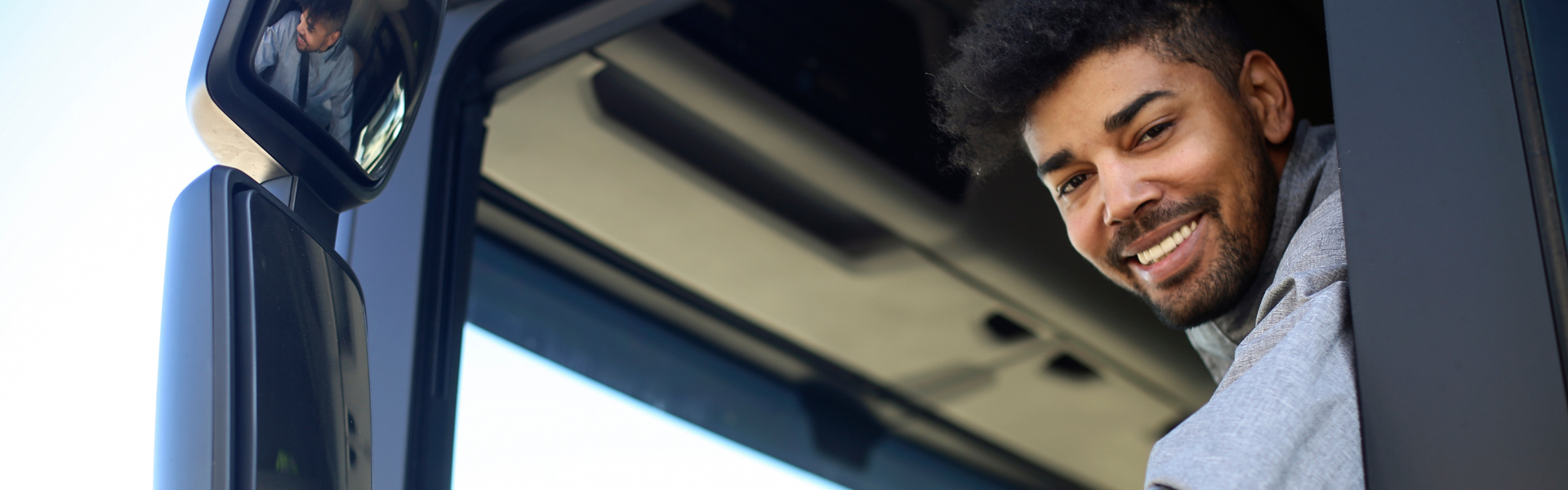 young black man in semi truck cab