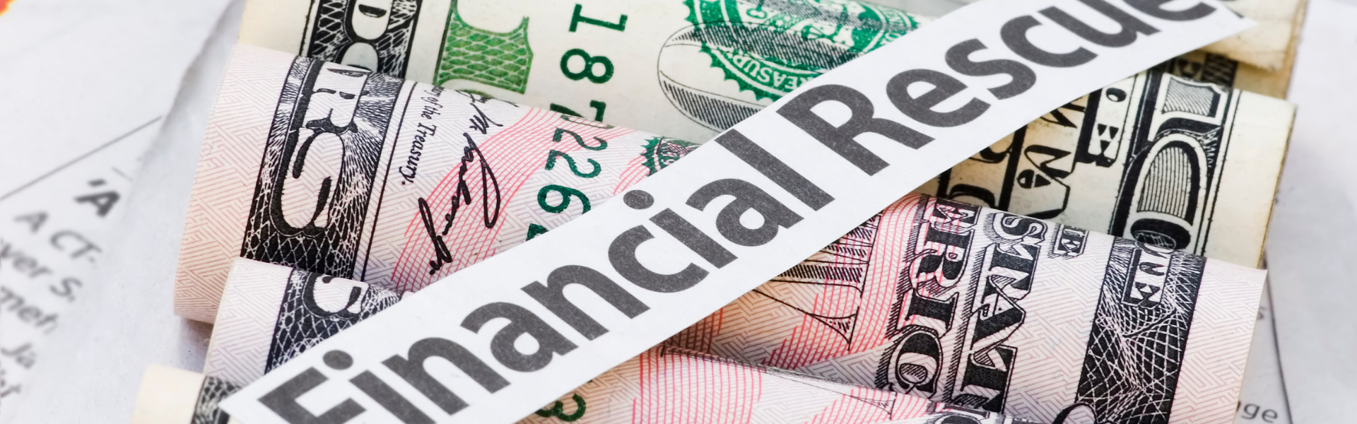 rolled money with a financial rescue label