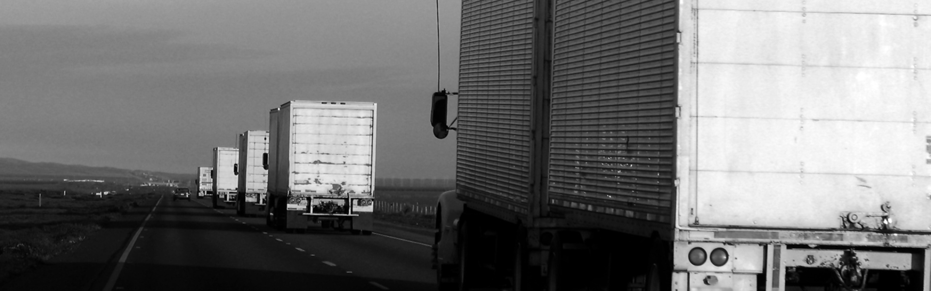 line of semi trucks on highway