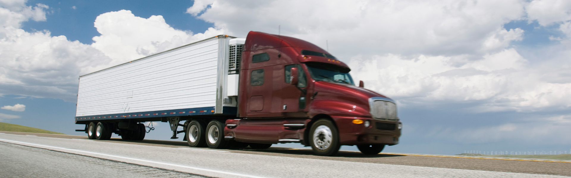 dark red semi truck on road