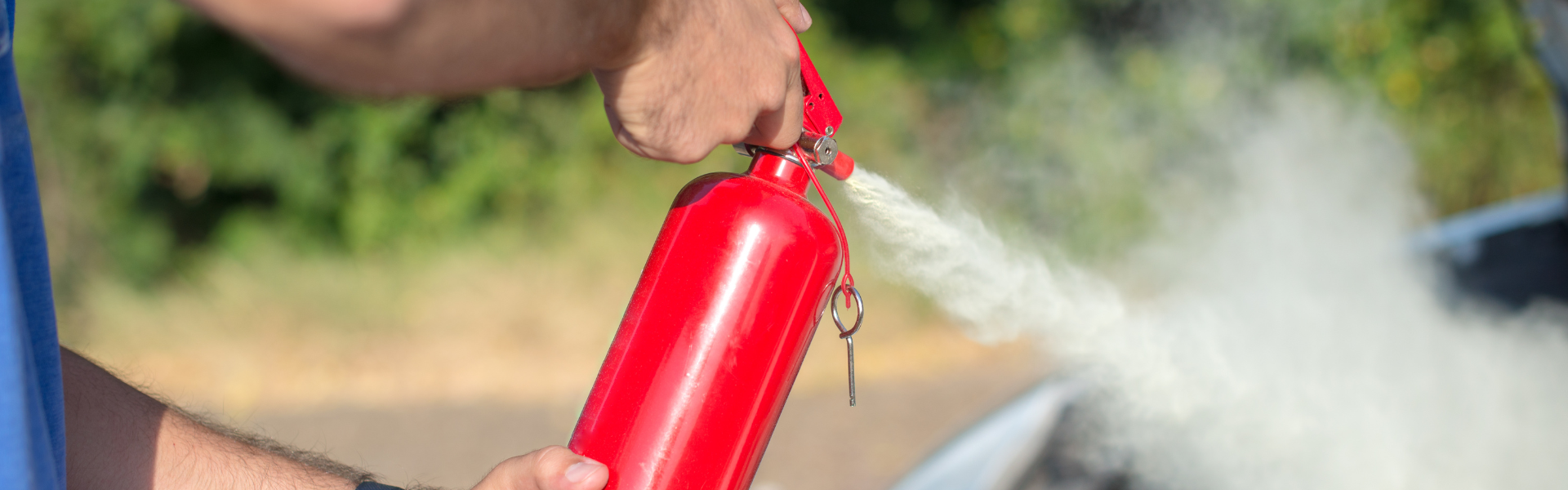 spraying fire extinguisher onto car