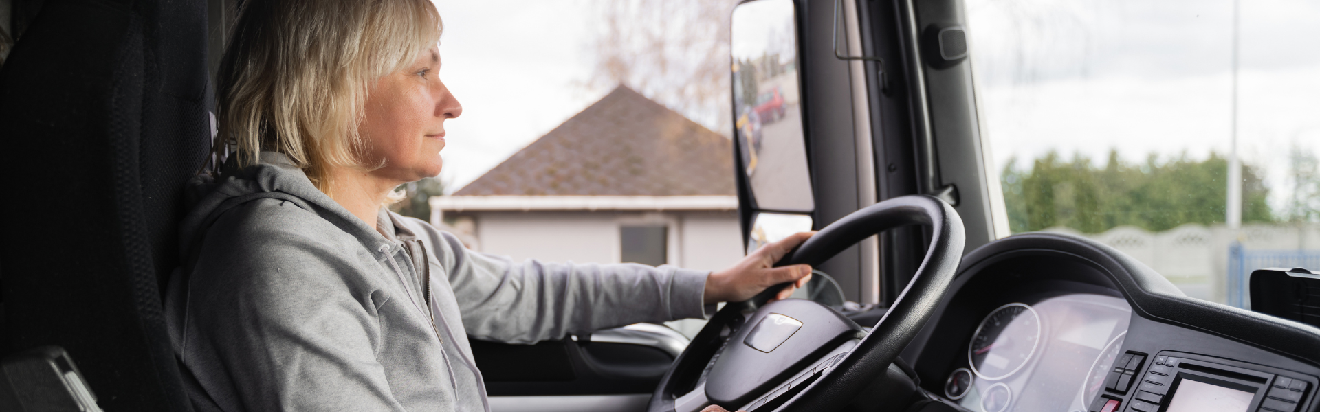 blonde woman driving semi truck