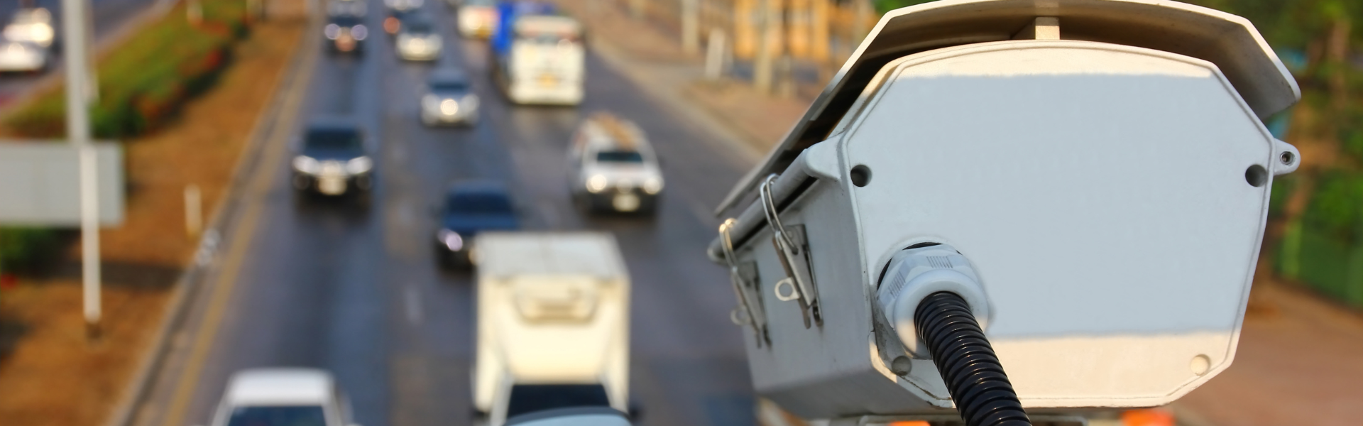 traffic camera pointing at road full of vehicles