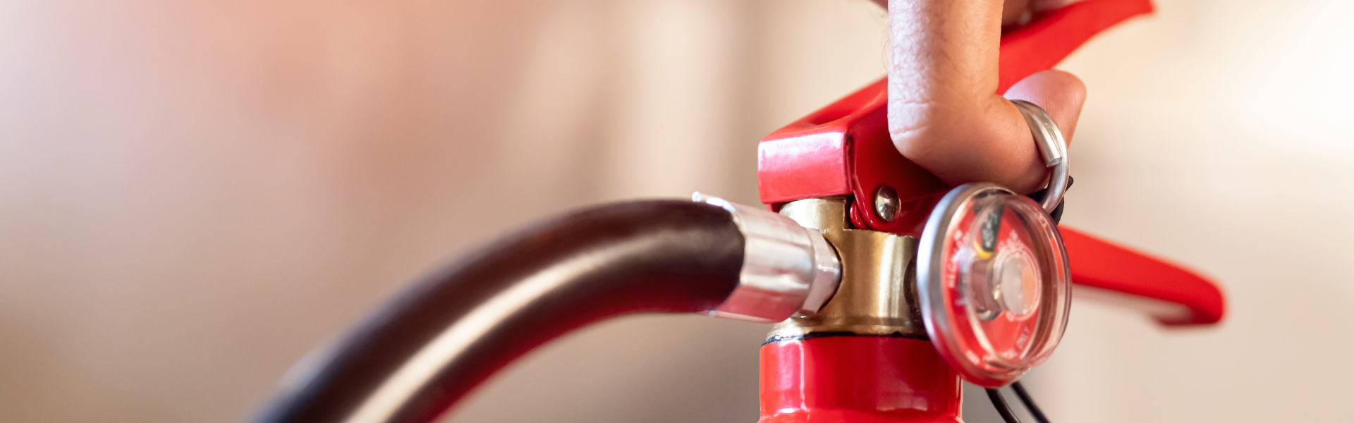 Hand holding fire extinguisher