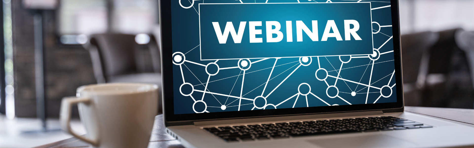 laptop opened to webinar with cup of coffee
