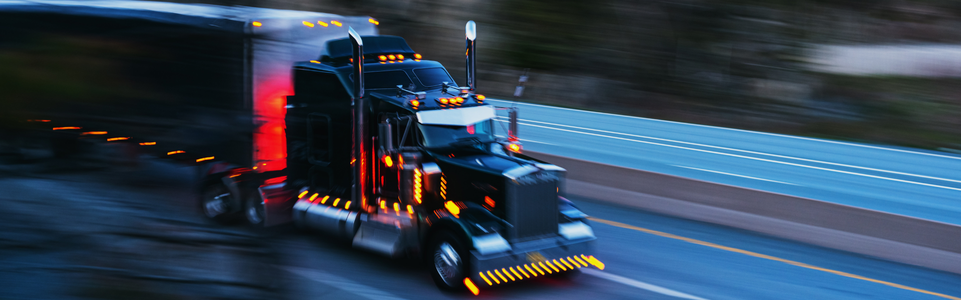 semi truck on road at dusk