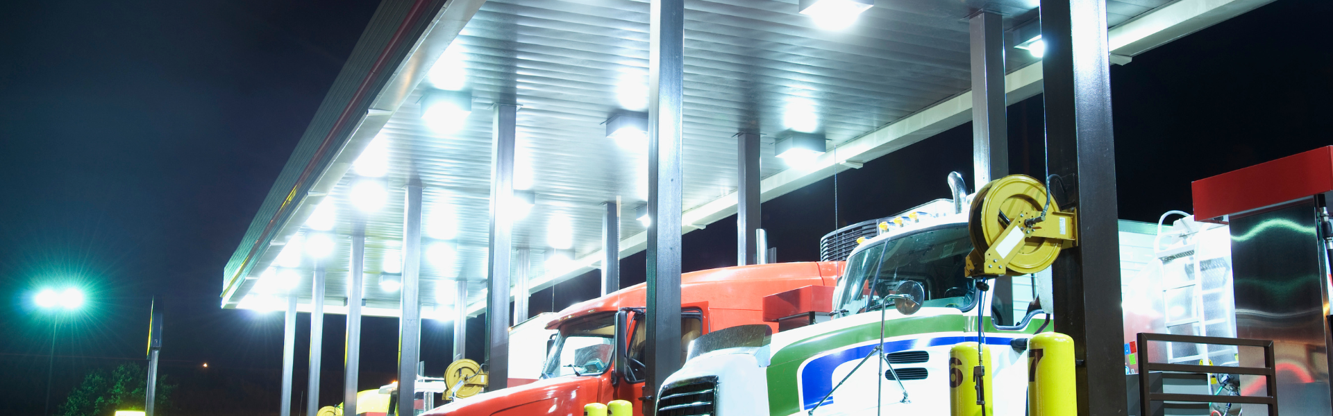 semi trucks parked at truck stop fuel pumps