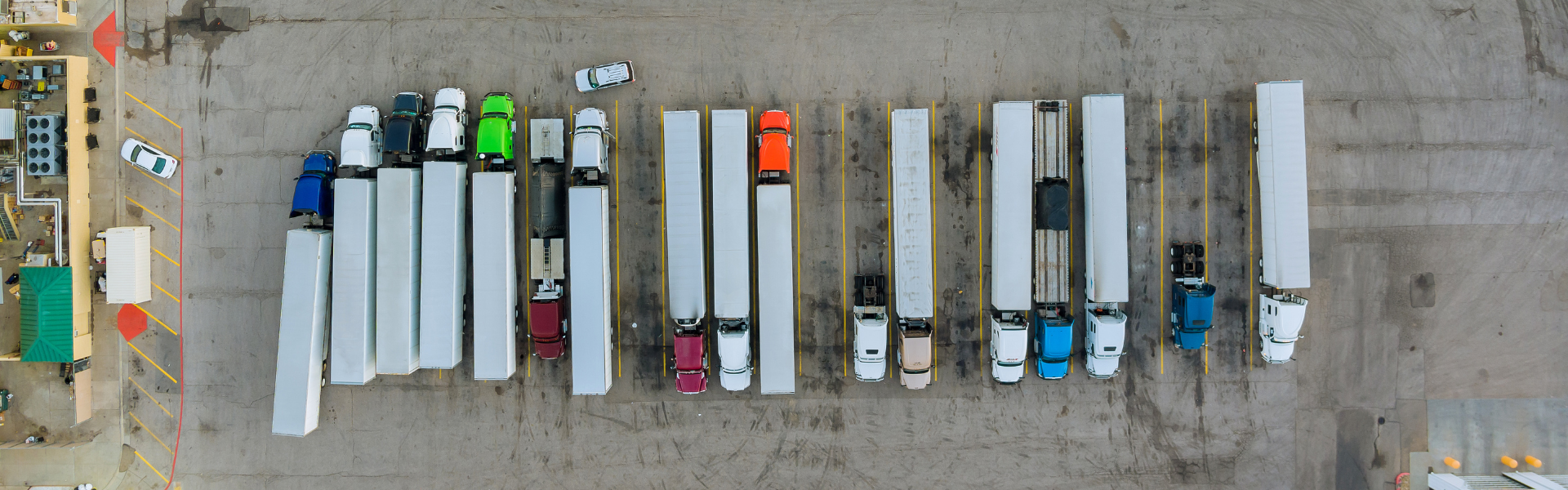 semi trucks parked in lot aerial