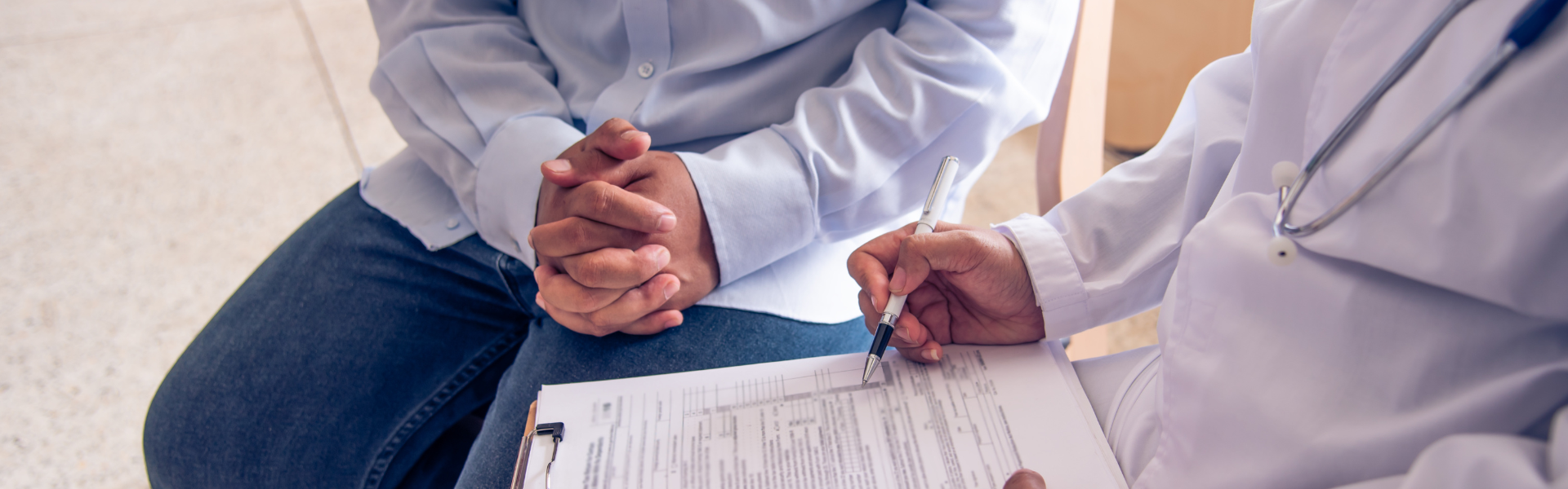 doctor filling out form with patient