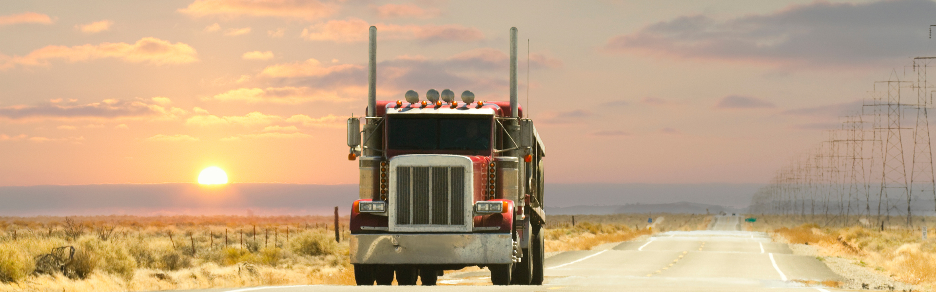 semi truck on road at sunset