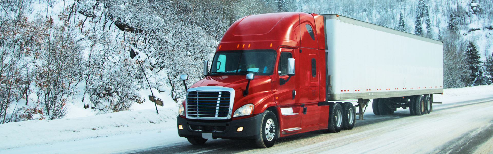 red semi truck on snowy road