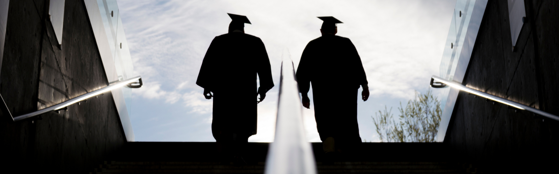 graduates walking up stairs