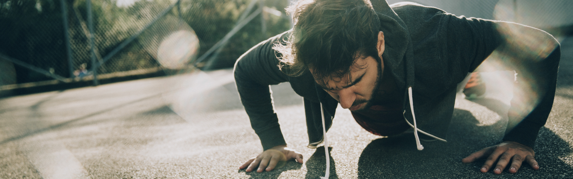 Man doing push ups in parking lot