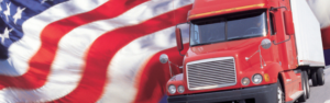 american flag waving behind red semi truck