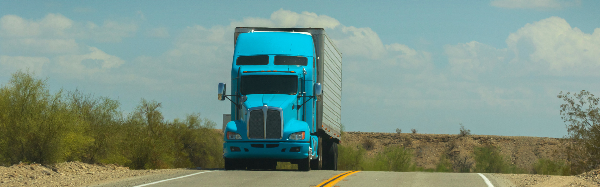 blue semi truck on road