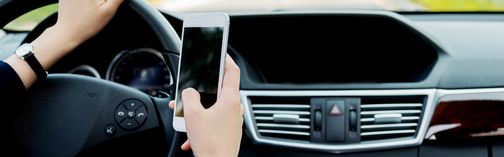 man using phone while driving