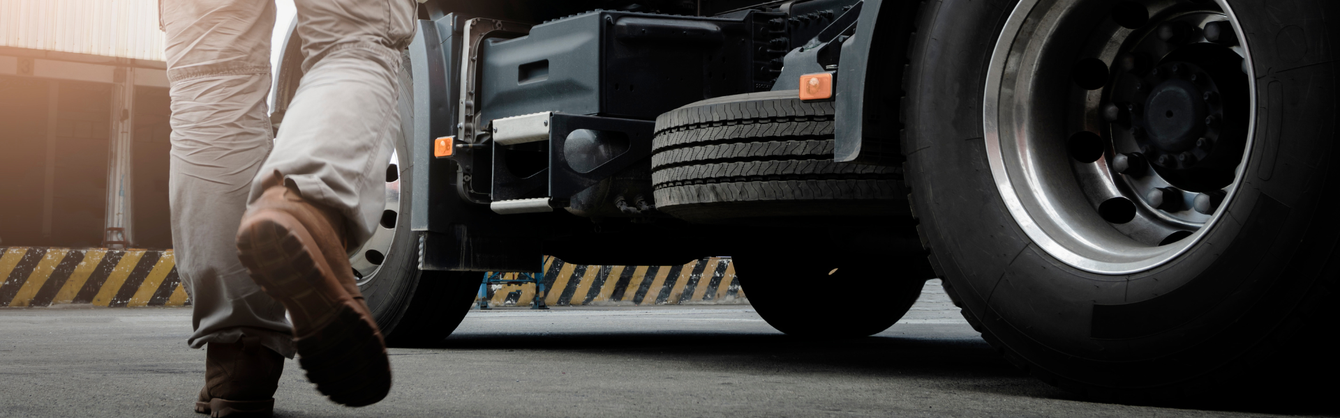 man in work boots walking towards semi truck