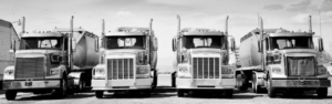 black and white photo of vintage semi trucks