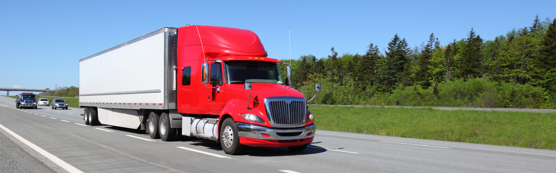 Red semi truck on road