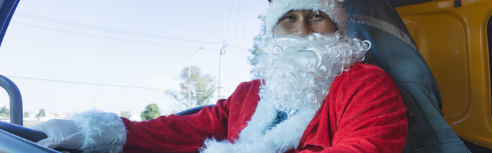 truck driver in semi truck cab dressed as santa